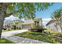 Beautiful two-story home with a well-manicured lawn and inviting two-car garage on a sunny day at 2850 Pewter Mist Ct, Oviedo, FL 32765