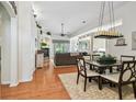 Open-concept living space featuring hardwood floors, a ceiling fan, and seamless flow to other areas at 404 Sotheby Way, Debary, FL 32713