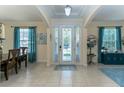 Bright foyer with tile flooring, elegant chandelier, and views into adjacent living spaces at 410 E Victoria Trails Blvd, Deland, FL 32724