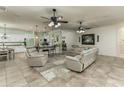 Open-concept living space with tile floors, ceiling fans, and seamless flow to the kitchen at 410 E Victoria Trails Blvd, Deland, FL 32724