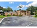 Brick building with peach shutters and large columns, set against a blue sky at 416 Banyon Tree Cir # 108, Maitland, FL 32751