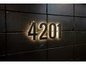 Illuminated address number '4201' mounted on a textured dark wall, providing clear and stylish identification at 4201 Mizell St, Orlando, FL 32812