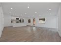 Spacious living area with recessed lighting, wood-look floors, and an open layout to the contemporary kitchen at 4201 Mizell St, Orlando, FL 32812