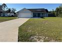 Charming single-story home with a well-manicured lawn and a two-car garage at 468 Marion Oaks Blvd, Ocala, FL 34473
