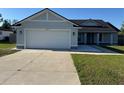 Charming single-story home with a well-manicured lawn and a two-car garage at 468 Marion Oaks Blvd, Ocala, FL 34473