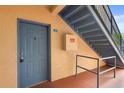 Entry door to unit 104 with stairway access, and an included fire safety box at 527 Villa Del Sol Cir # 104, Orlando, FL 32824
