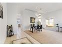 Dining room featuring new carpet, a modern light fixture, and a bright window at 558 Cadiz Loop, Davenport, FL 33837