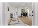 Bright and open entryway with tile flooring, staircase and adjacent dining room at 558 Cadiz Loop, Davenport, FL 33837