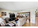 Inviting living room with hardwood floors and neutral decor, featuring a large sofa and entertainment center at 619 Byron Rd, Winter Park, FL 32792
