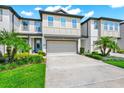 Charming two-story townhouse with attached two-car garage and well-manicured landscaping at 652 Benoi Dr, Davenport, FL 33896