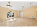 Bright and airy living room featuring tile flooring, a ceiling fan, and a large window at 6819 Belmar Dr, Orlando, FL 32807