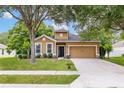 Charming single-Gathering home with a well-manicured lawn, beautiful trees, and a welcoming front door at 805 Gordonia Ct, Deland, FL 32724