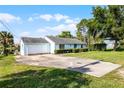 Charming light blue one-story home with a long driveway near the water at 8121 Via Bonita, Sanford, FL 32771