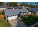 Charming single-Gathering home featuring a grey roof, stone accents, and well-manicured lawn at 838 Haulover Dr, Altamonte Springs, FL 32714