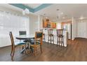 Open-concept dining area adjacent to the kitchen offers sleek hardwood floors and plenty of natural light at 106 Turtle Run, Umatilla, FL 32784