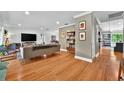 Bright living room featuring hardwood floors, comfortable seating, and stylish decor with easy access to the backyard at 1202 Marshall Ct, Eustis, FL 32726