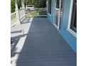 Spacious porch with wooden decking and white railings, perfect for outdoor relaxation at 13111 Sunshine Cir, Clermont, FL 34711