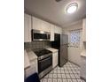 Cozy kitchen featuring stainless steel appliances and blue patterned flooring at 151 N Orlando Ave # 118, Winter Park, FL 32789