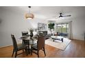 Open concept living room and dining area featuring hardwood floors and natural light at 184 Sandlewood Trl # 2, Winter Park, FL 32789