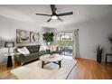 Bright living room with hardwood floors, stylish furnishings, and a sliding glass door to the patio at 184 Sandlewood Trl # 2, Winter Park, FL 32789