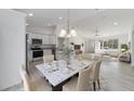 A dining area adjacent to a modern kitchen, complete with stylish furnishings and abundant natural light at 1900 Sw 178Th Street Rd, Ocala, FL 34473