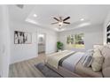 Serene main bedroom with tray ceiling, ensuite bathroom, and large windows offering ample natural light at 1900 Sw 178Th Street Rd, Ocala, FL 34473