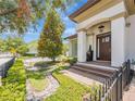 Charming home with a covered front porch, brick steps and meticulously maintained landscaping at 242 W Lyman Ave, Winter Park, FL 32789