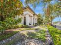 A charming two-story home featuring meticulously maintained landscaping with stone and greenery at 242 W Lyman Ave, Winter Park, FL 32789
