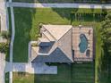 Aerial view of a home with a screened-in pool and spacious backyard at 25859 Crossings Bluff Ln, Sorrento, FL 32776