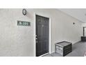 Close-up of a unit's front door with a black finish and secure entry system at 2627 Maitland Crossing Way # 101, Orlando, FL 32810