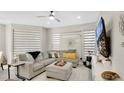 A modern living room with a comfortable gray sectional sofa, stylish decor, and ample natural light at 2627 Maitland Crossing Way # 101, Orlando, FL 32810