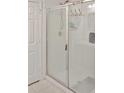 Shower with clear glass doors and white tiled walls at 2835 Mosshire Cir, St Cloud, FL 34772