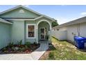 Inviting front entry with an arched covered doorway and flower bed at 2903 Willow Oak Ct, Kissimmee, FL 34744