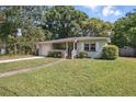 Well-kept single-story home with lush green lawn and mature trees at 2915 Hargill Dr, Orlando, FL 32806