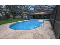 Enjoy this backyard pool with a screened enclosure for outdoor entertainment at 2928 Ne 14Th Ave, Ocala, FL 34479