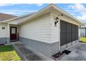Close up exterior view of home displaying the front door and attached screened garage at 2966 Derby Dr, Deltona, FL 32738
