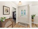 Bright and airy entryway with hardwood floors and stylish decor, creating a warm and inviting first impression at 315 Pickering Ct, Longwood, FL 32779