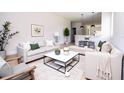 Bright living room with neutral paint, wood floors, modern furniture, and decorative accents at 33 W 7Th St, Apopka, FL 32703