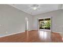 Bright living room with hardwood floors and sliding glass doors leading to the outdoor patio at 3304 Bennington Ct, Winter Park, FL 32792