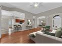 Bright, open-concept living room featuring hardwood floors, modern decor and seamless flow into the kitchen at 3304 Bennington Ct, Winter Park, FL 32792