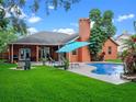 Enjoy a private pool and outdoor kitchen on the rear of this attractive house at 3518 Edlingham Ct, Belle Isle, FL 32812