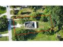 Large lot featuring a charming home in a lush, green setting and an outlined property at 455 Orange Ave, St Cloud, FL 34769