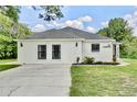 Inviting single-story home featuring a well-kept lawn, black framed windows, and a welcoming entrance at 455 Orange Ave, St Cloud, FL 34769