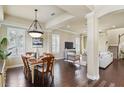 Open dining room featuring dark wood floors, ample windows, and an elegant chandelier at 5303 Brady Ln, Orlando, FL 32814