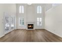 Bright living room with a fireplace, soaring ceilings, neutral color palette, and lots of natural light at 554 Queensbridge Dr, Lake Mary, FL 32746