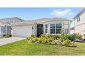 Beautiful home with manicured lawn, brick paved driveway and attached two car garage at 5641 Oak Knoll Dr, St Cloud, FL 34771