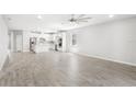 Open concept living room and kitchen with tile floors and modern ceiling fan at 5641 Oak Knoll Dr, St Cloud, FL 34771