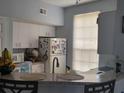 Efficient kitchen layout with modern appliances and a breakfast bar at 6316 Raleigh St # 401, Orlando, FL 32835