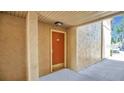 A front door with neutral walls and flooring and an overhang on a sunny day at 648 Kenwick Cir # 102, Casselberry, FL 32707