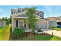 Charming two-story home with a covered front porch and a well-manicured lawn at 700 Trotters Dr, Eagle Lake, FL 33839
